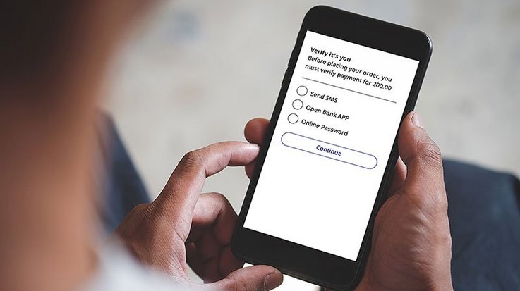 Someone operates a smartphone on which a verification process is displayed