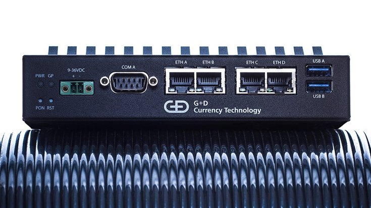 A small black box with USB, and various network cable ports and the inscription G+D Currency Technology.