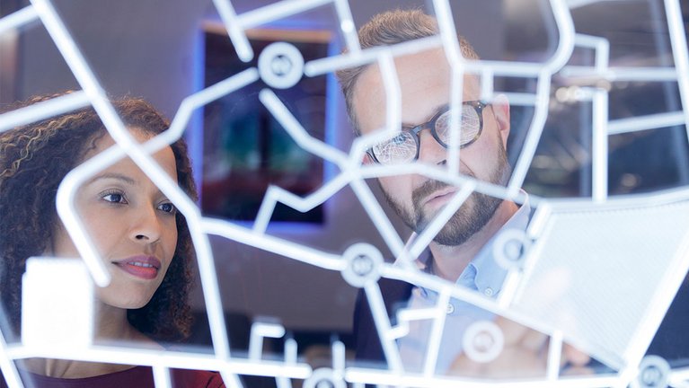View through patterned glass on a man and a woman discussing something