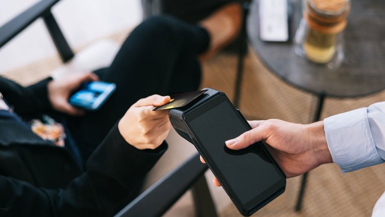 A woman paying with her ceramic payment card