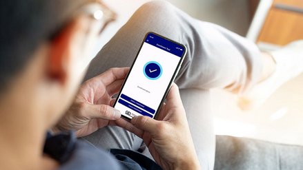 A man operates a G+D app on his smartphone