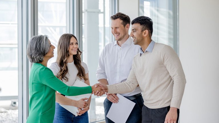 Businesspeople shaking hands in office