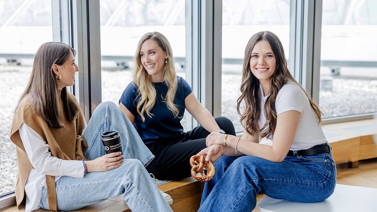 Colleagues relaxing with coffee and pretzel