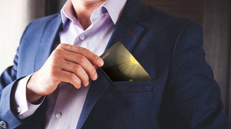 A man putting his ceramic payment card in his jacket pocket 