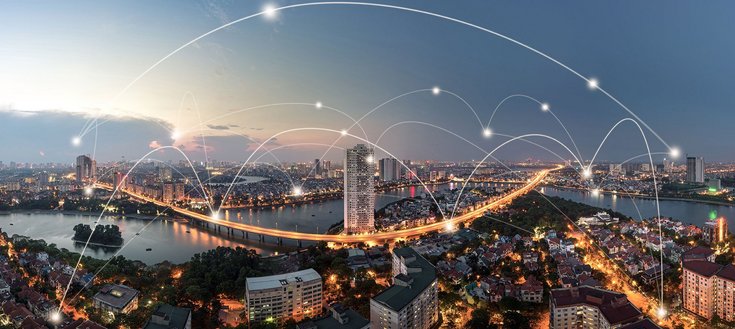 Cityscape with data connection lines arching over the sky