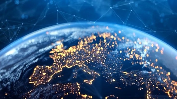View of Earth from space showing illuminated cities in Europe with digital network connections.