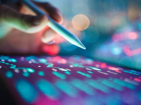 Business technology coding with prompting into an AI assistant on a tablet with digital pen