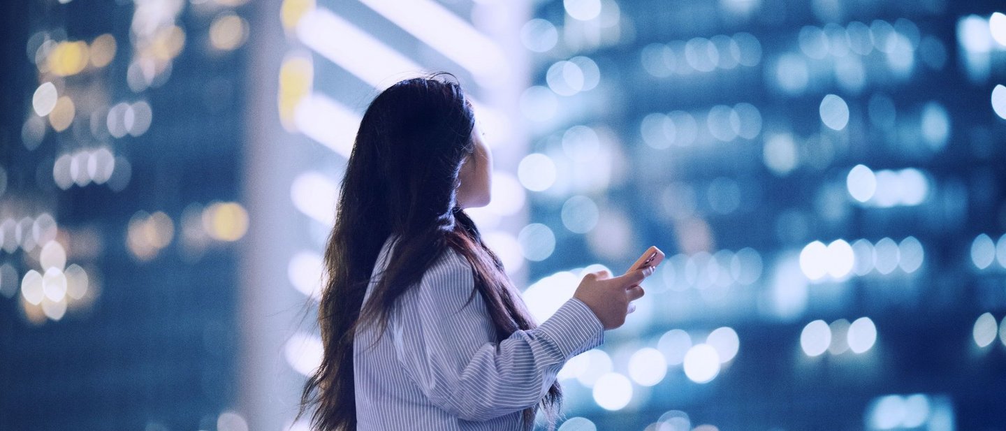 Women with mobile phone in urban surroundings