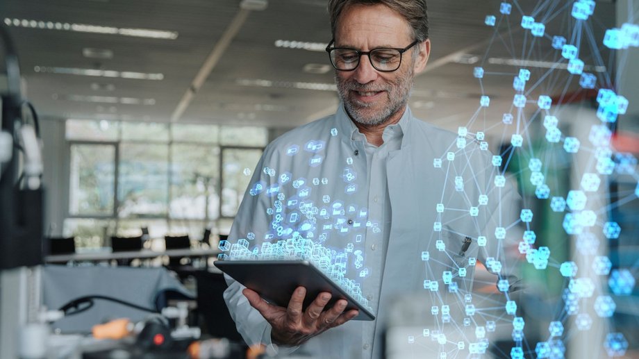 Man holding a mobile device in an office environment