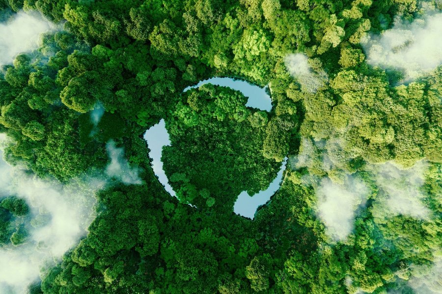 Three ponds arranged as arrows, amidst green trees, form the recycling symbol