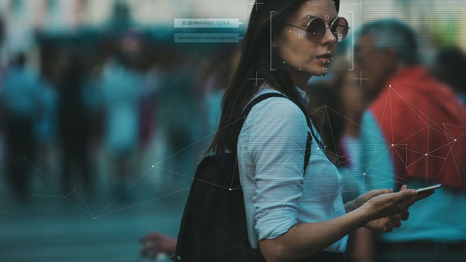 Woman with sunglasses holding smartphone in her hand