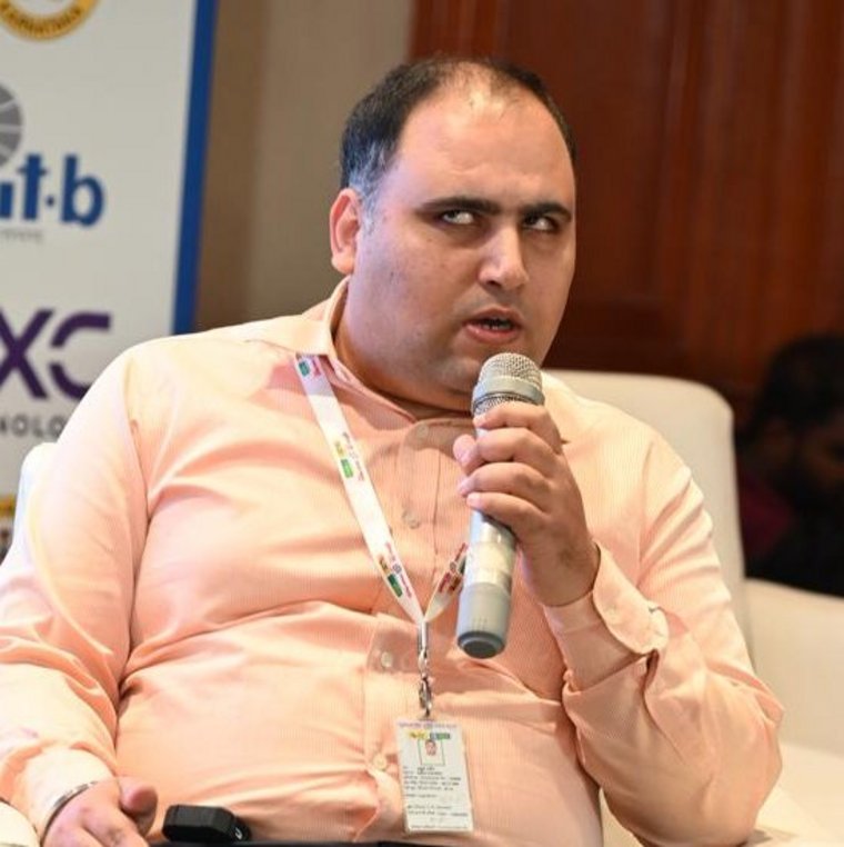 Portrait of Rahul Gambhir from Union Bank of India speaking into a microphone.