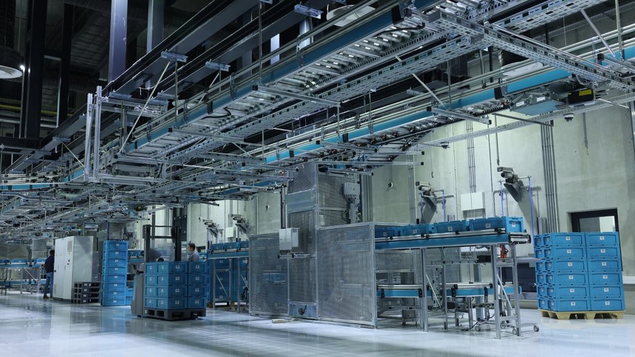 Modern and secure cash center in Angola featuring automated systems, conveyors, and blue crates