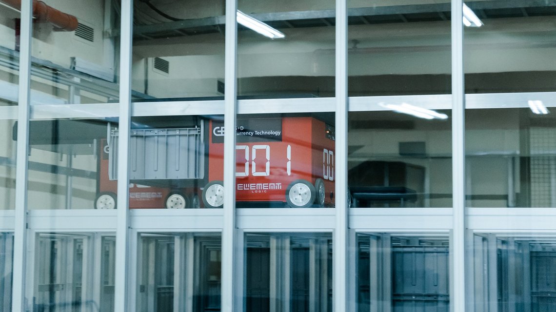 Model of a red train behind glass windows