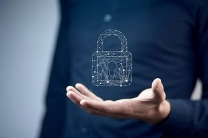 A man holding a symbol of a digital lock, symbolizing security or protection in the digital space..