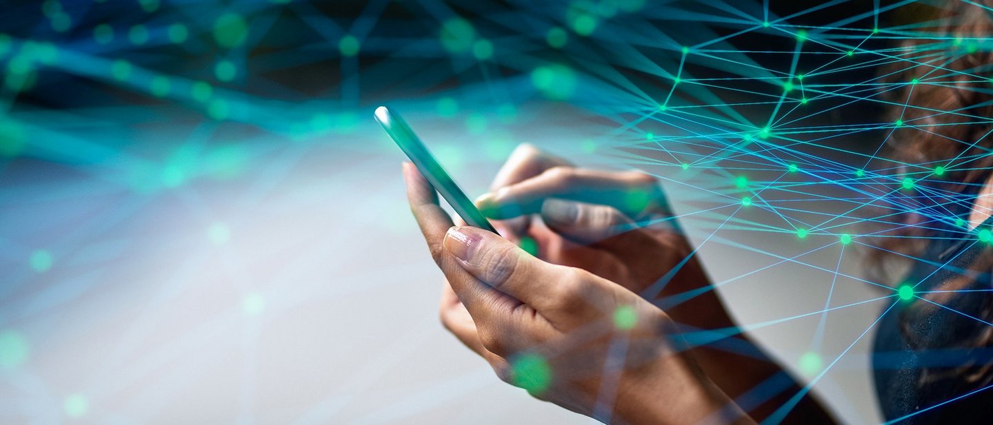A woman operates a smartphone, above which lies a simulated digital network with many nodes