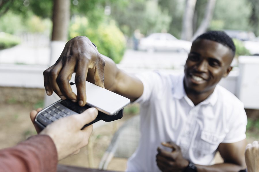 A man uses his smartphone to pay