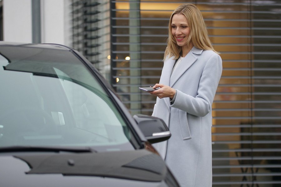 Woman opens her car with her mobile