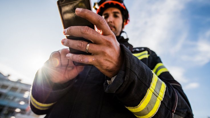 Firefighter on duty with mobile phone