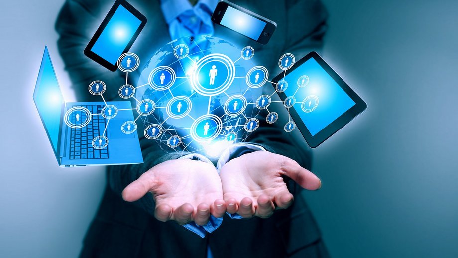 Businessman with a digital layer of several devices