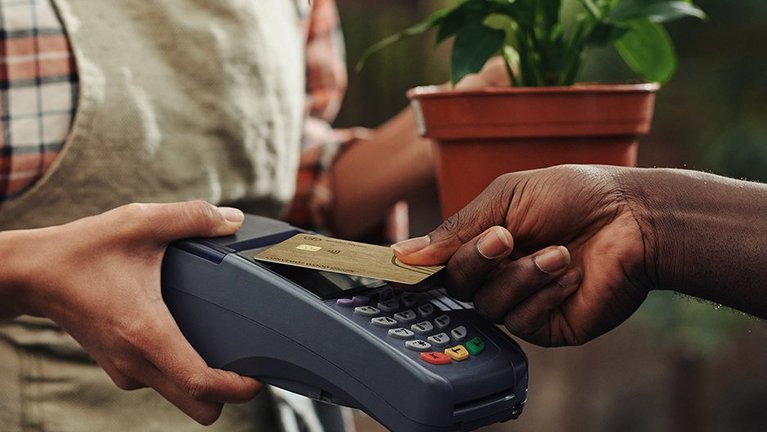 person using a wooden payment card during payment process
