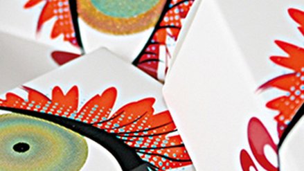 Three paper boxes each with an artfully depicted eye on it