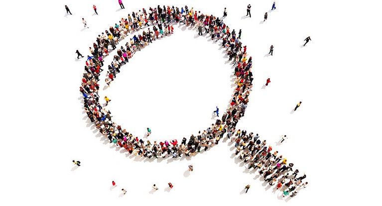 Many people form a magnifying glass from above through a formation