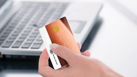 A person holds a StarSign FIDO card in his hand