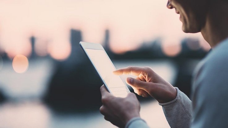 A man tapping on his smartphone