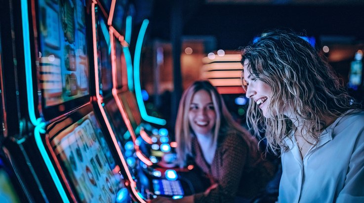 Two women at the slot machine
