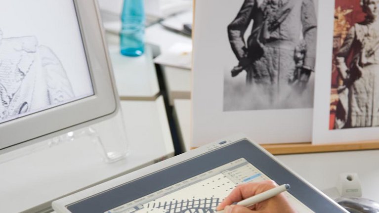 A man finishes sketches on a digital drawing board