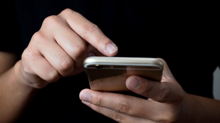 Closeup of a person clicking on their smartphone