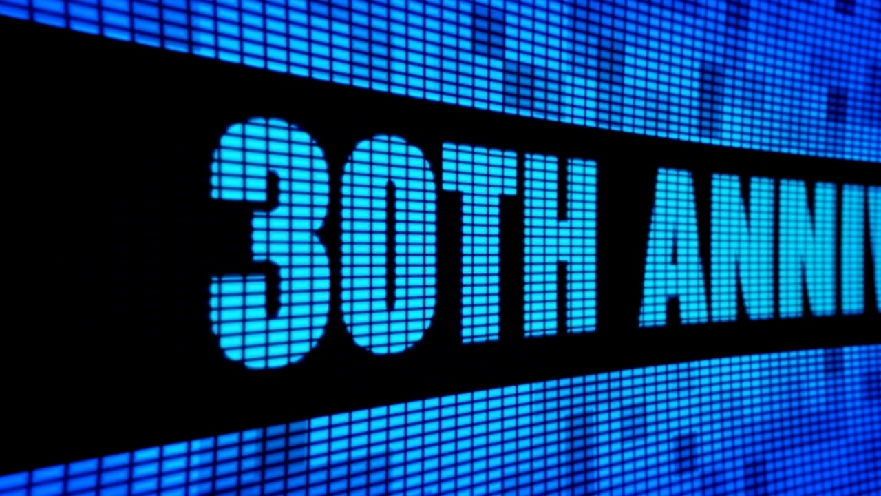 Blue and black illuminated sign with the inscription 30TH ANNIVERSARY