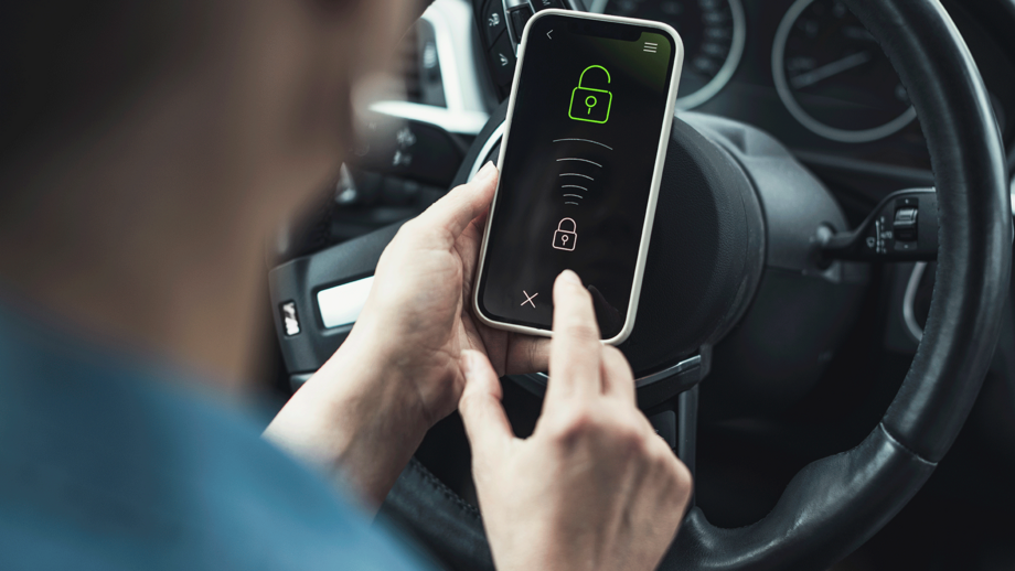 Woman unlocking mobile phone in car