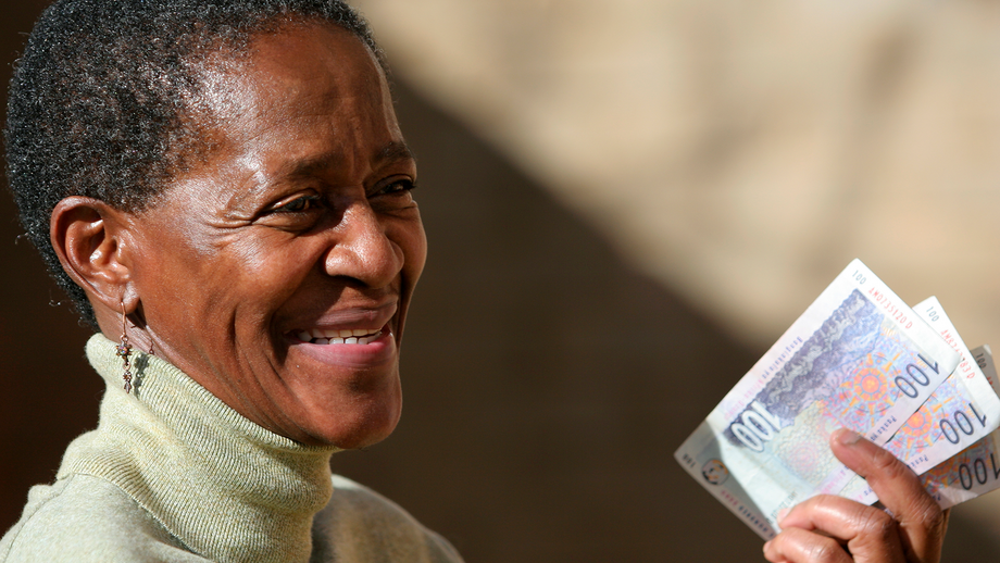 A woman holding cash in her hand